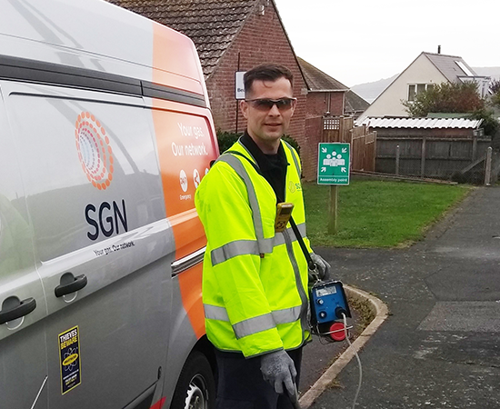 SGN engineer Nathan stands outside his van