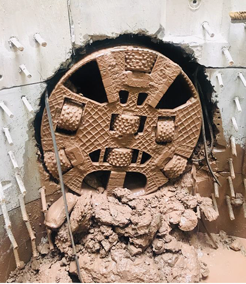 The tunneling machine pushing through the wall.