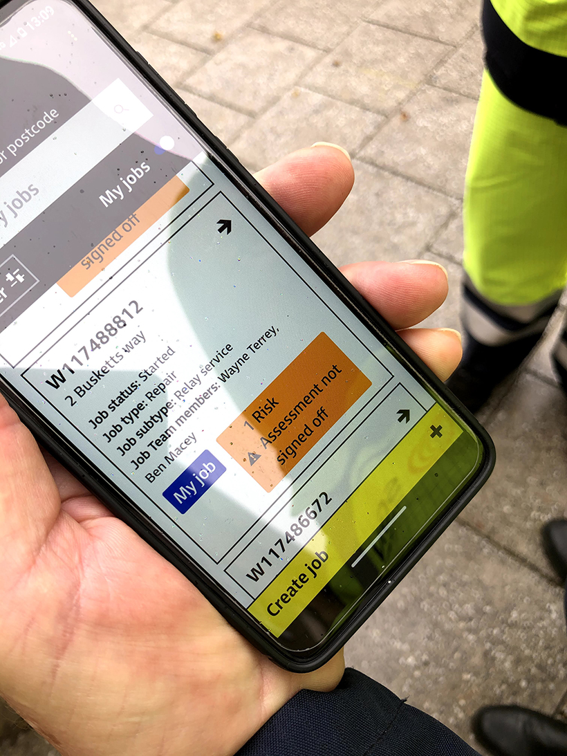 Engineer holding phone displaying new award-winning FYLD safety app