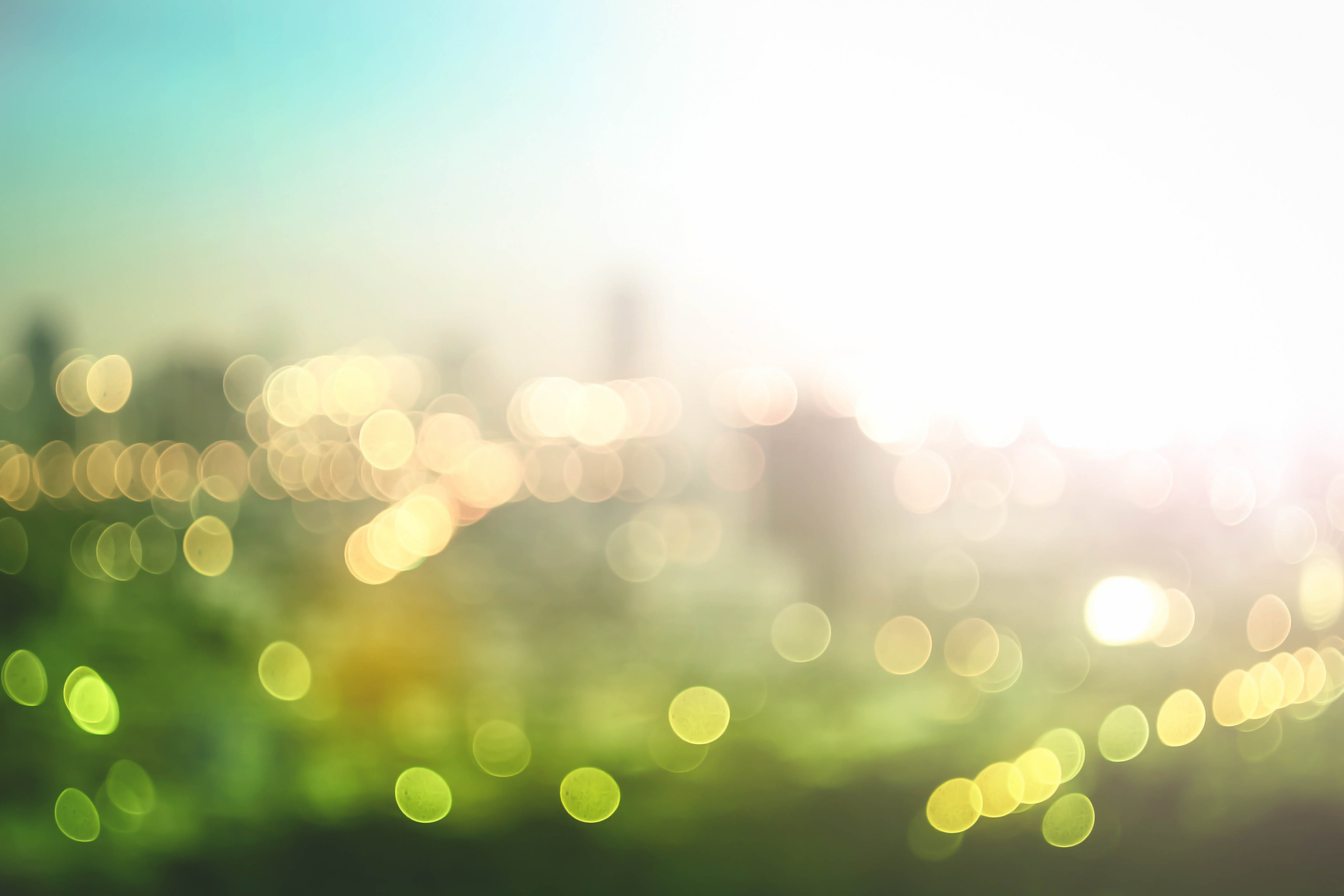 Blurry image of sunrise over a green field.