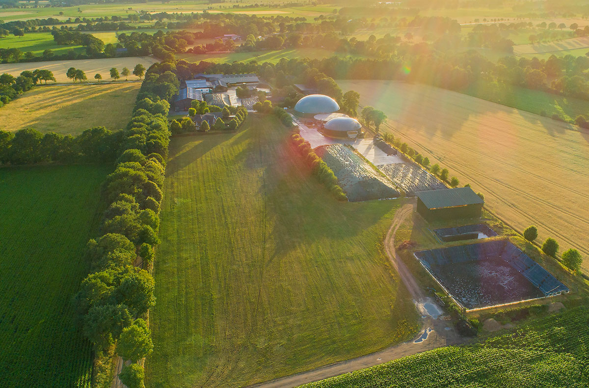 An aerial view of a biomethane plant surrounded by fields