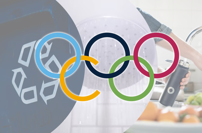 A recycling bin, shower and resuable water filled with tap water are the backdrop to five Olympic rings adapted to read 'CO'
