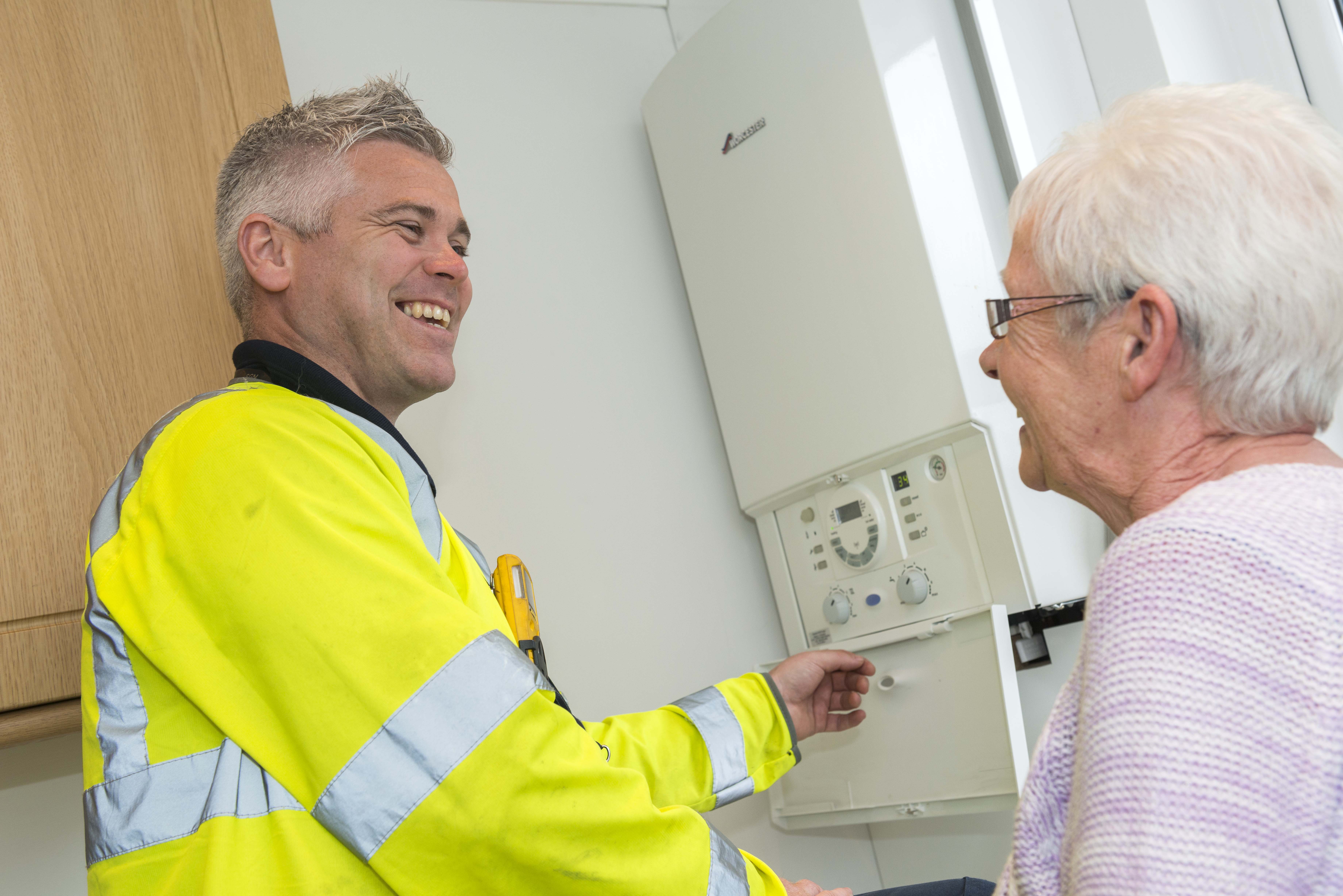 Engineer with boiler and older woman