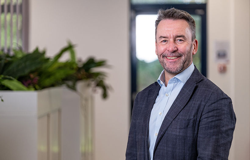 Mark Wild, CEO of SGN, standing in an office wearing a jacket and shirt