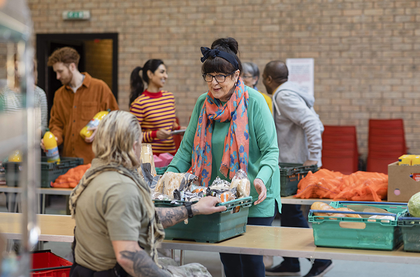 image shows a foodbank, two woman are talking