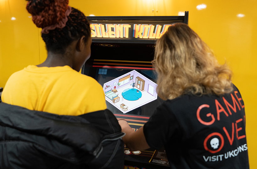 2 people playing the game over arcade game