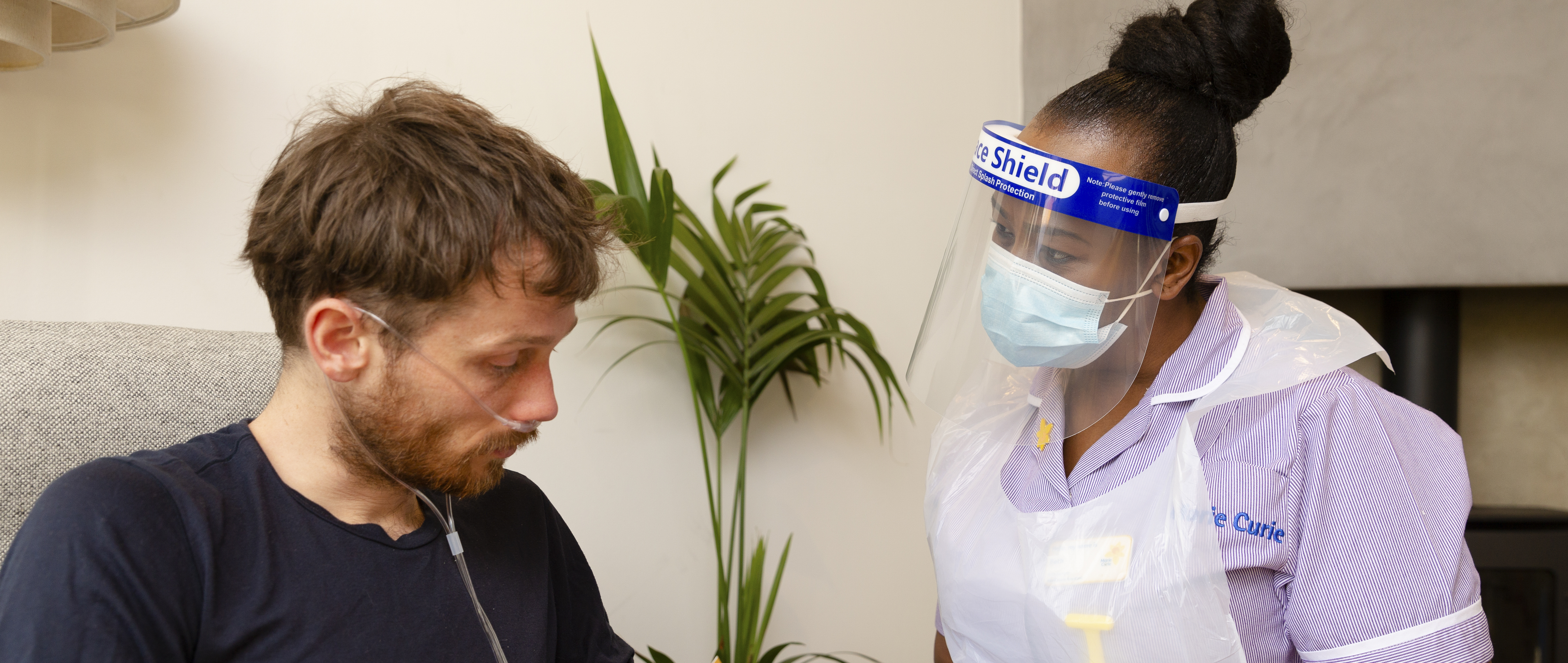 Marie Curie nurse showing a male patient some information