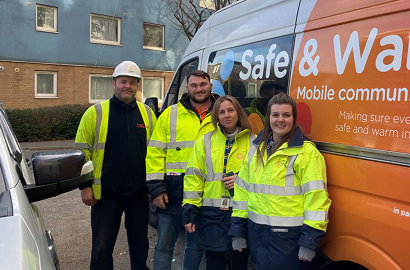 5 SGN staff members stand in front of an SGN safe and warm van