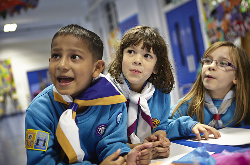 2 girls and one boy wearing blue beavers uniforms 