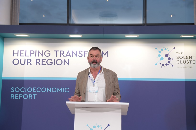 Our Hydrogen Solutions Lead Fergus Tickell standing at a podium discussing the launch of a new socioeconomic report
