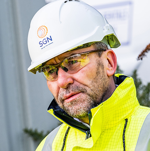 Man wearing safety glasses and hard hat