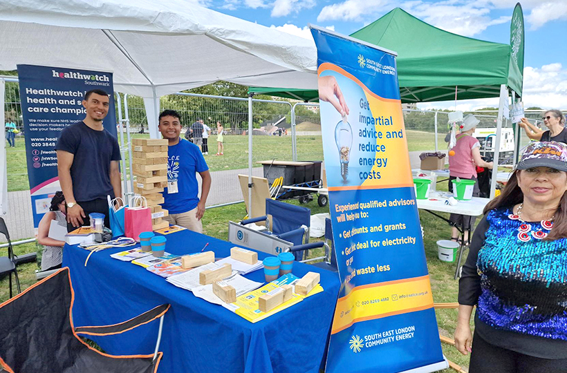 A group of smiling people at a stall providing energy advice