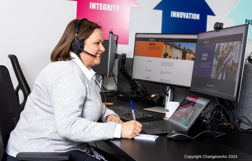 A Changeworks adviser sitting at a desk with two computer screens