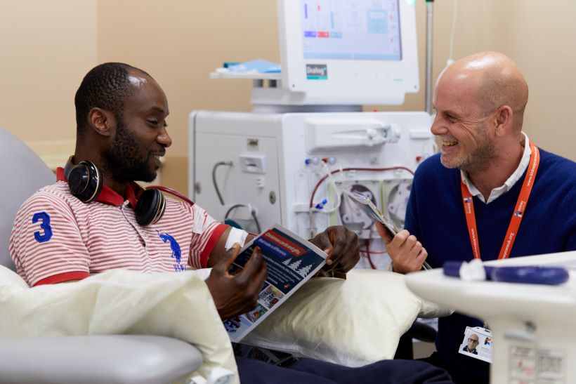 A kidney patient having dialysis is speaking with one of the Kidney Care UK team