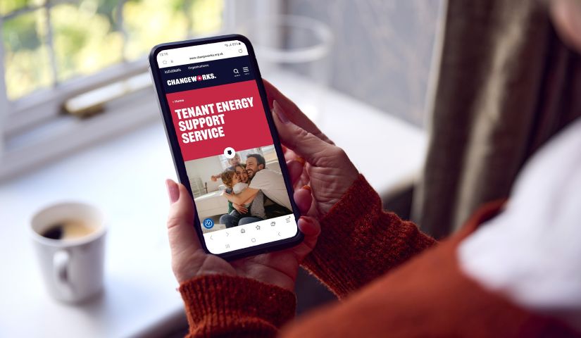 A close-up shot of a smartphone displaying the Changeworks Tenant Energy Support Service website