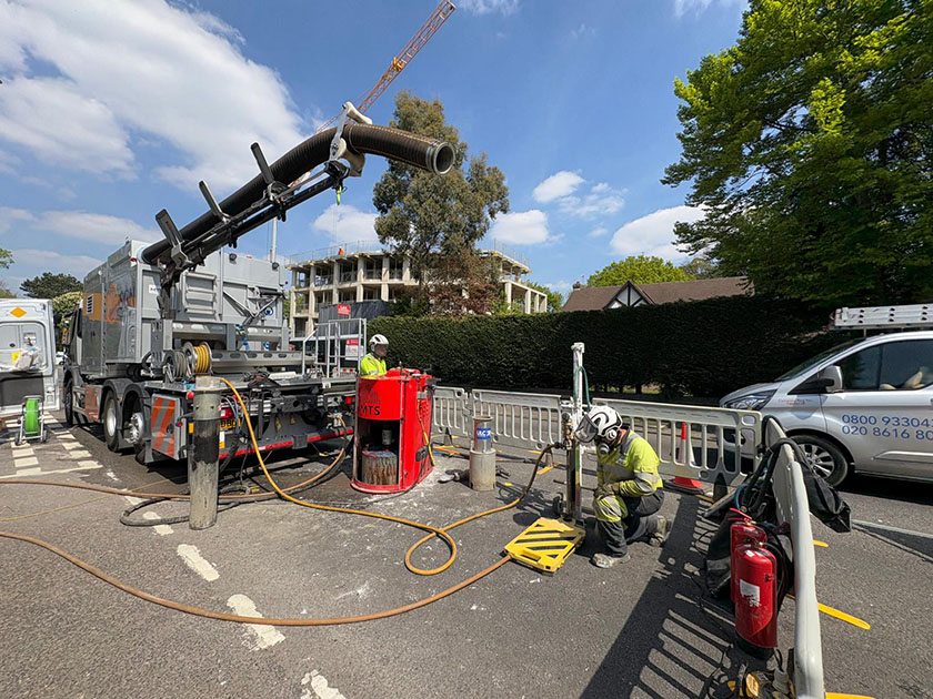 SGN's new Core & Vac Mk3 excavation and reinstatement vehicle at roadworks site in Purley with engineers using equipment