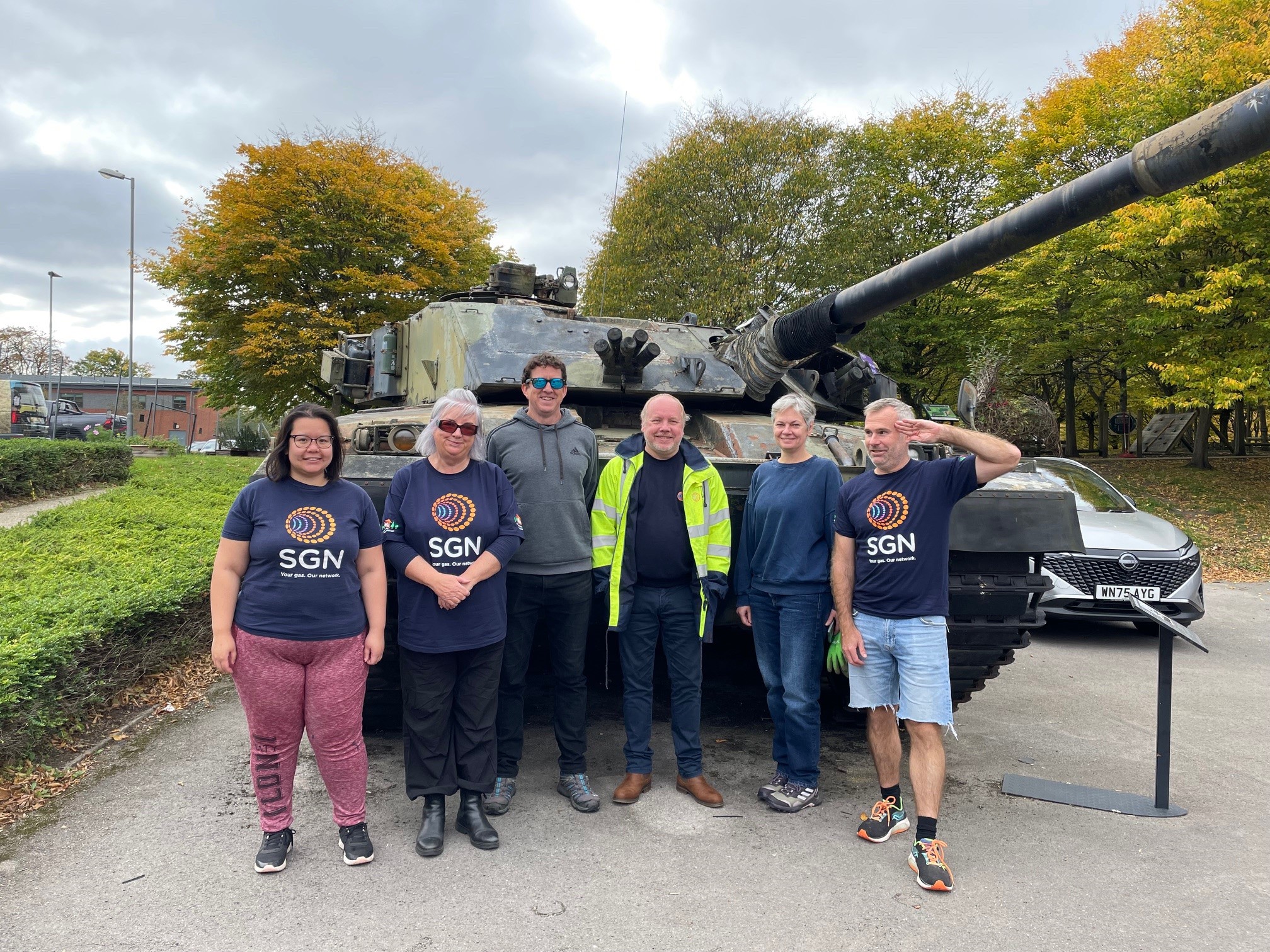 SGN volunteers stand in front of a military tank at Aldershot's military museum