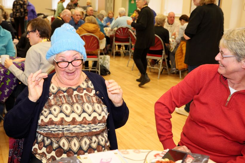 Guest sitting around tables at the Frodsham Bee Friends warm space