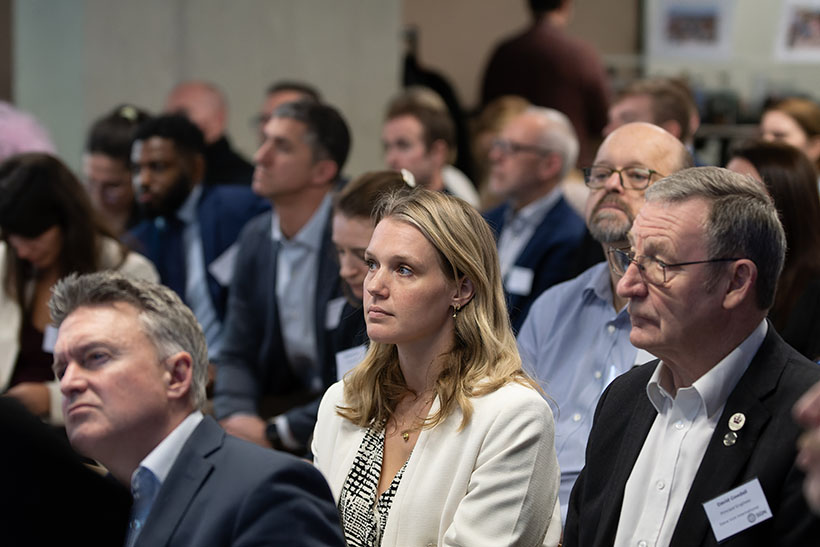 Men and women listening to one of the speakers at SGN's Innovation Showcase event
