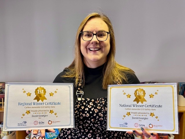 Headteacher Katie Willis ready to present Daniel with his winner’s certificates 