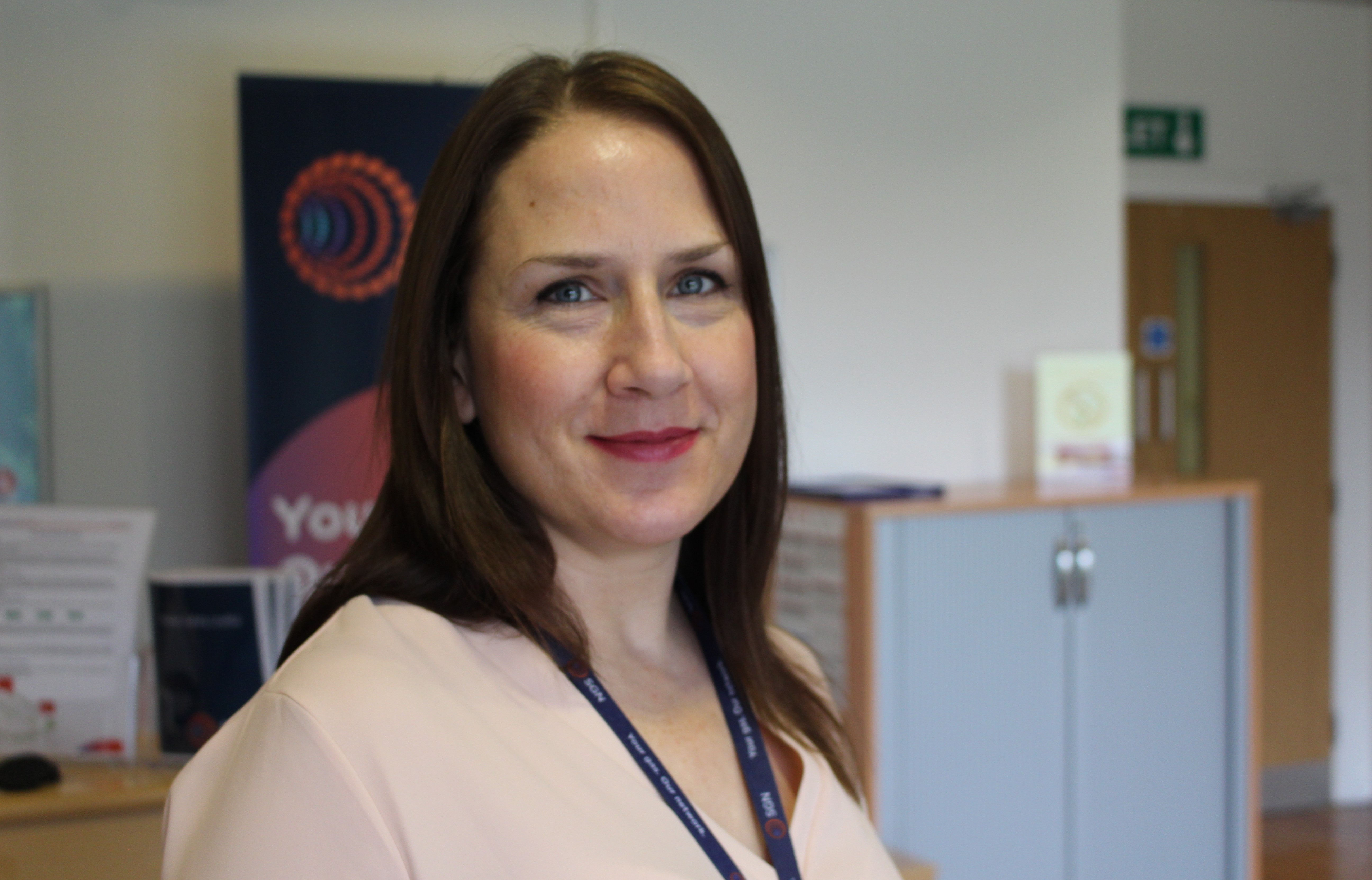 Head and shoulders of SGN female employee in business attire