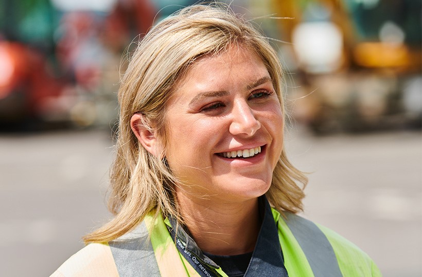 Head and shoulders of SGN female employee wearing protective clothing