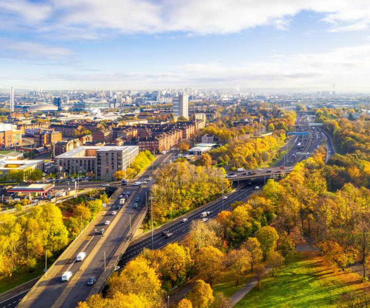 Aerial View of Glasgow with trees and motorway in foreground