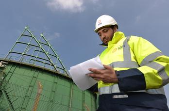 An SGN engineer standing outside of Horley gasholder