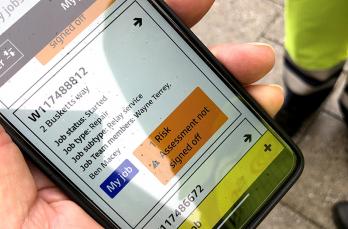 Engineer holding phone displaying new award-winning FYLD safety app