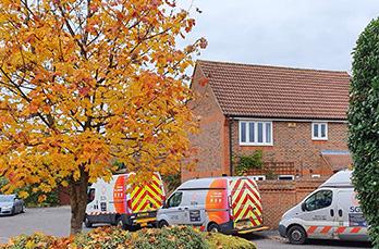 Three SGN vans parked in a suburban street