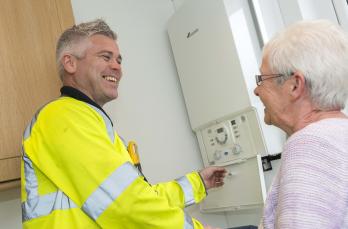 Engineer with boiler and older woman