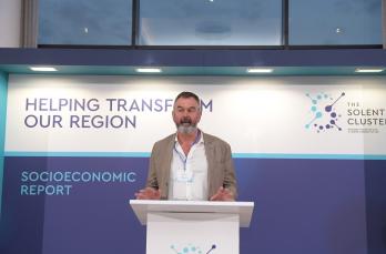 Our Hydrogen Solutions Lead Fergus Tickell standing at a podium discussing the launch of a new socioeconomic report
