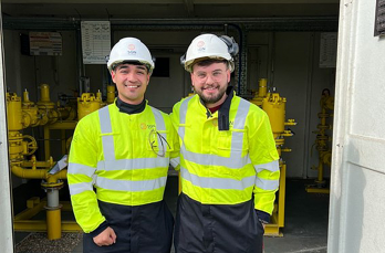 Two smiling SGN engineers in PPE
