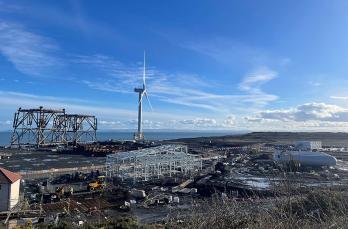 A construction site with turbine in the background