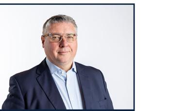 Head and shoulders image of Simon Kilonback, CEO of SGN. He wears glasses and a dark suit.
