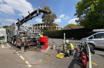 SGN's new Core & Vac Mk3 excavation and reinstatement vehicle at roadworks site in Purley with engineers using equipment