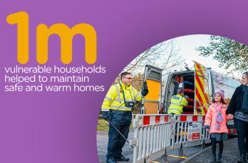 An engineer behind some barriers waving to a child and her mother