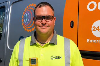 A smiling man in SGN branded PPE